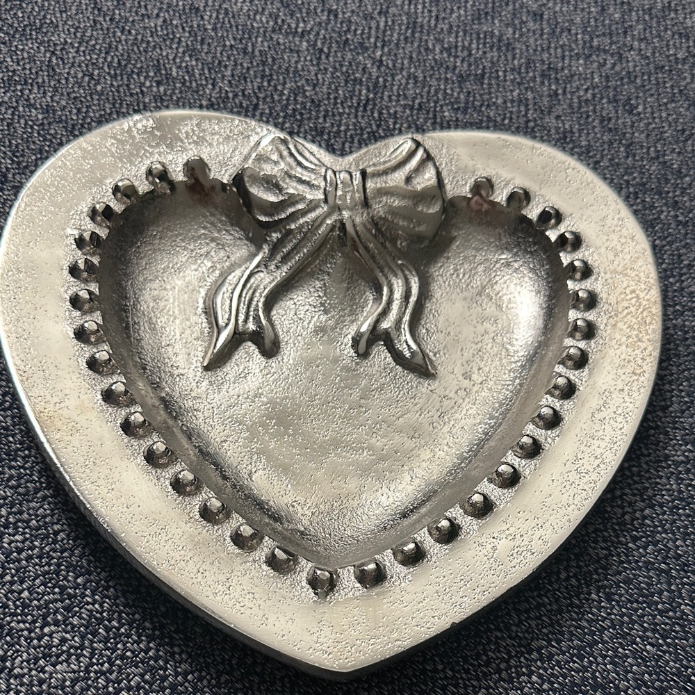 Heart-shaped decorative dish/ tray made of silver-tone metal.